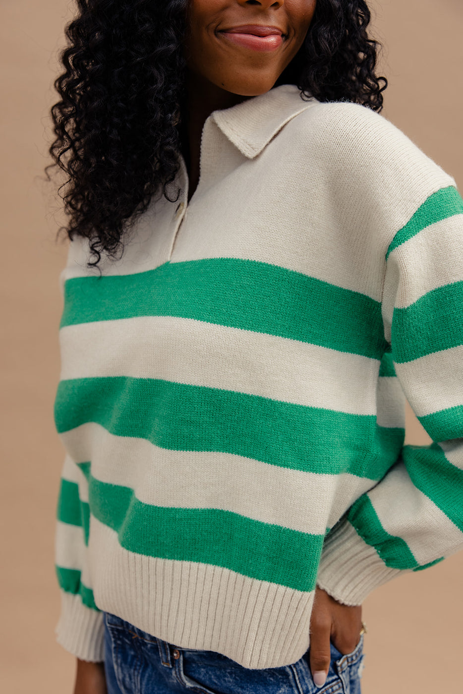 a woman wearing a green and white striped sweater