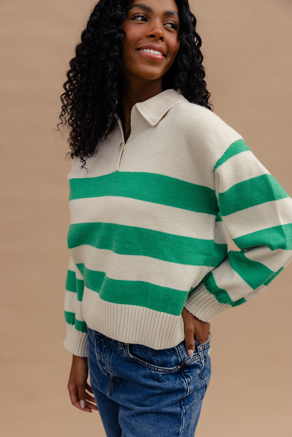 a woman wearing a green and white striped sweater