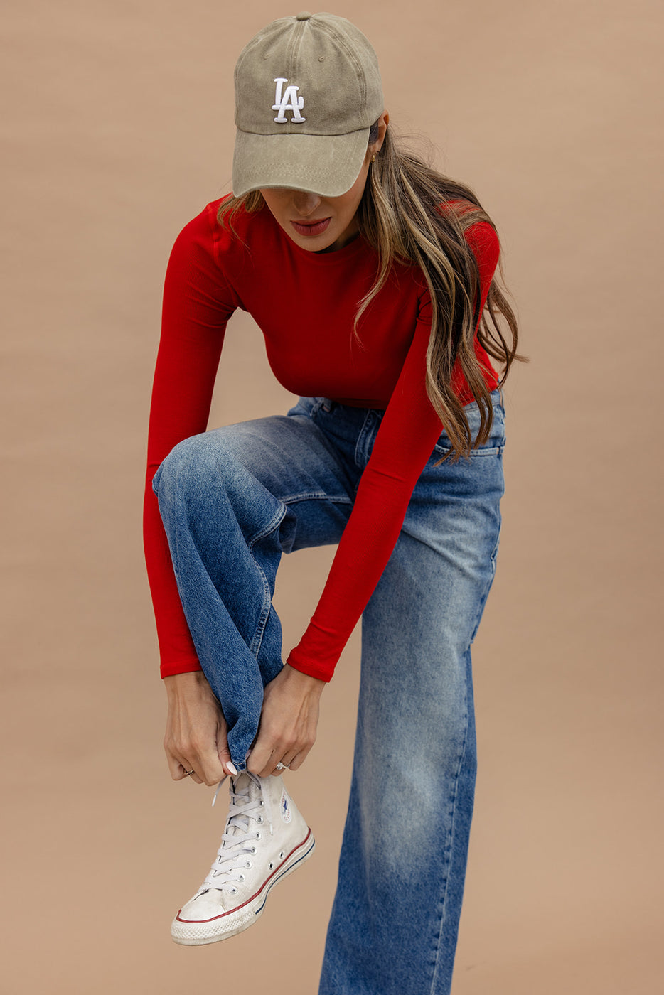 a woman wearing a hat and a red shirt