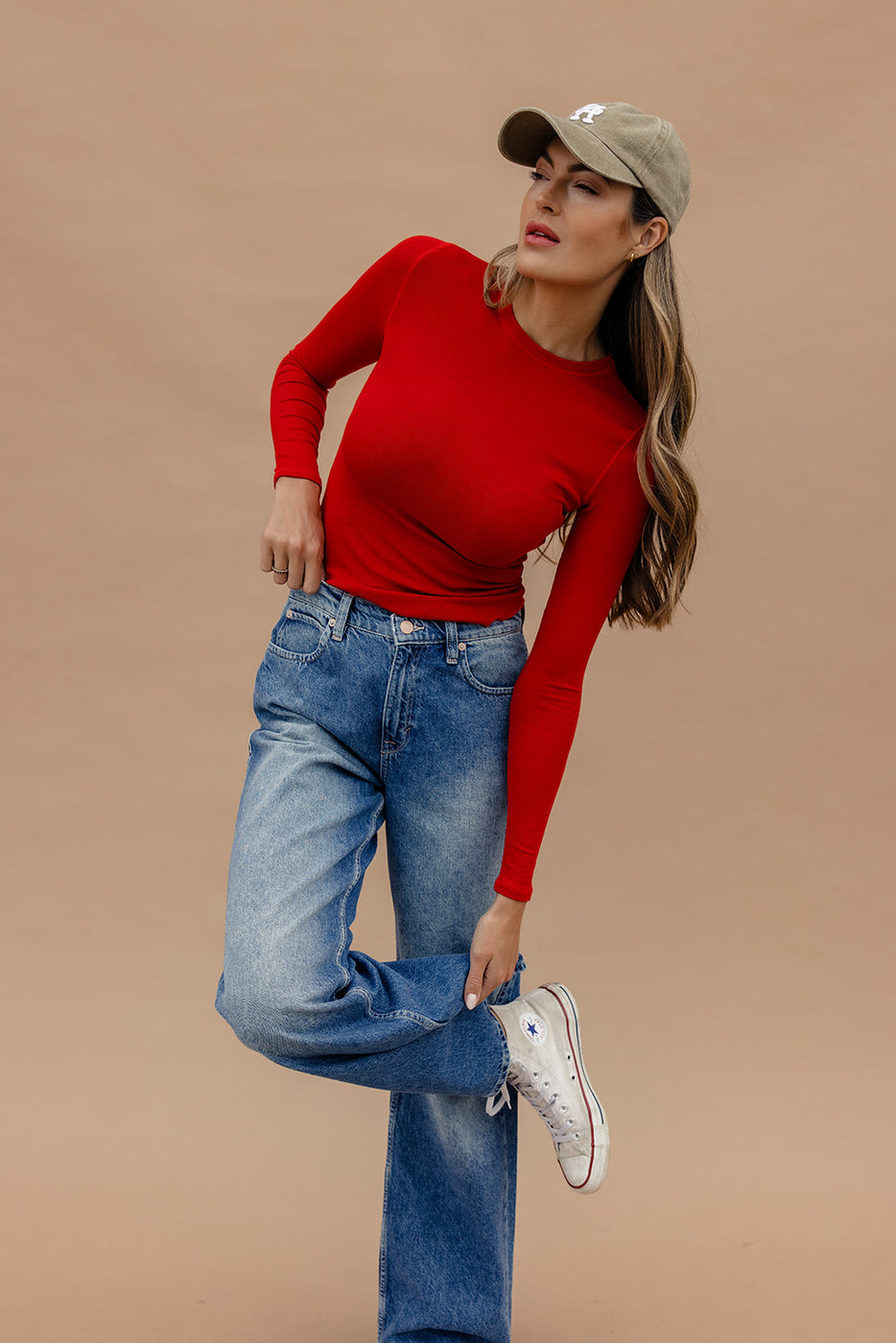 a woman in a red shirt and jeans