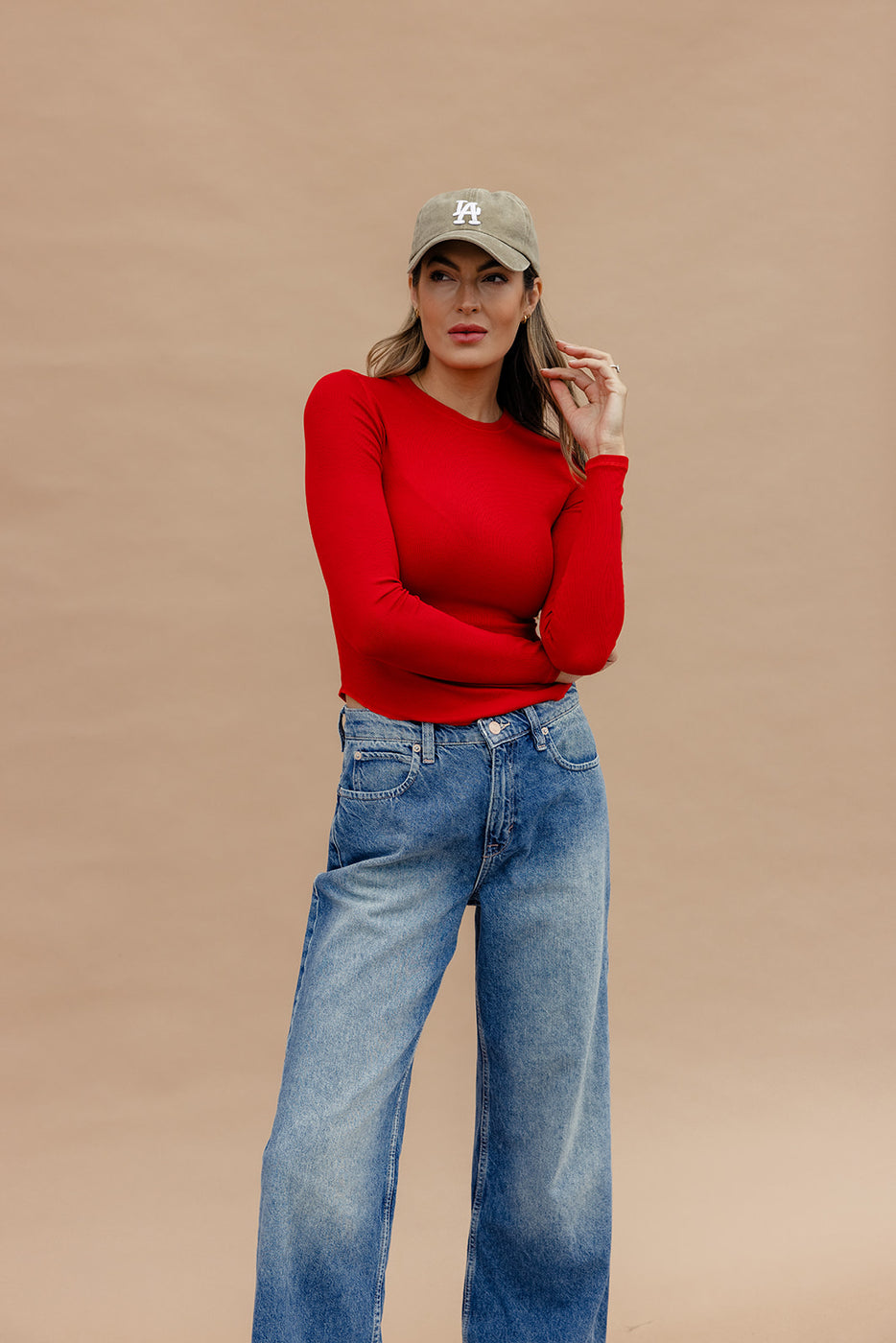 a woman in a red shirt and blue jeans