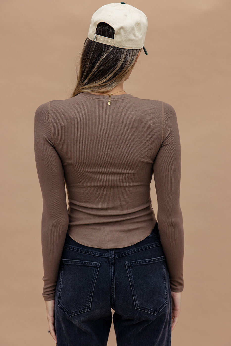 a woman in a brown shirt