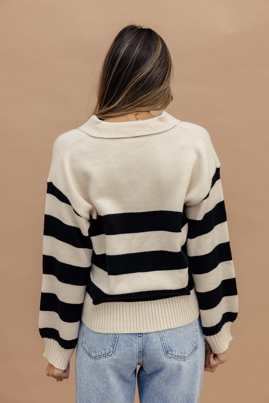 a woman wearing a striped sweater