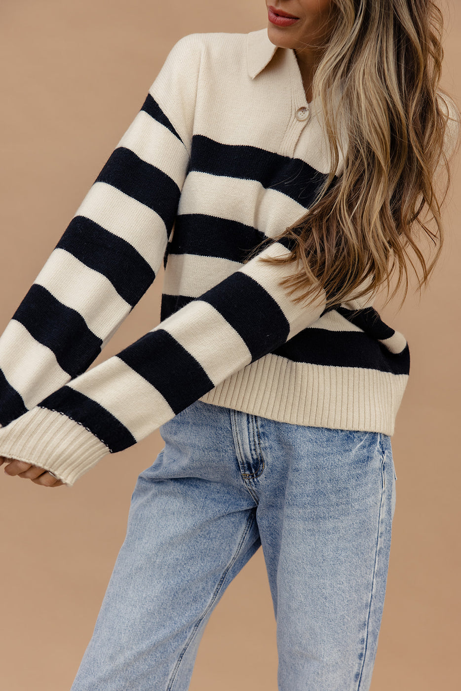 a woman wearing a striped sweater