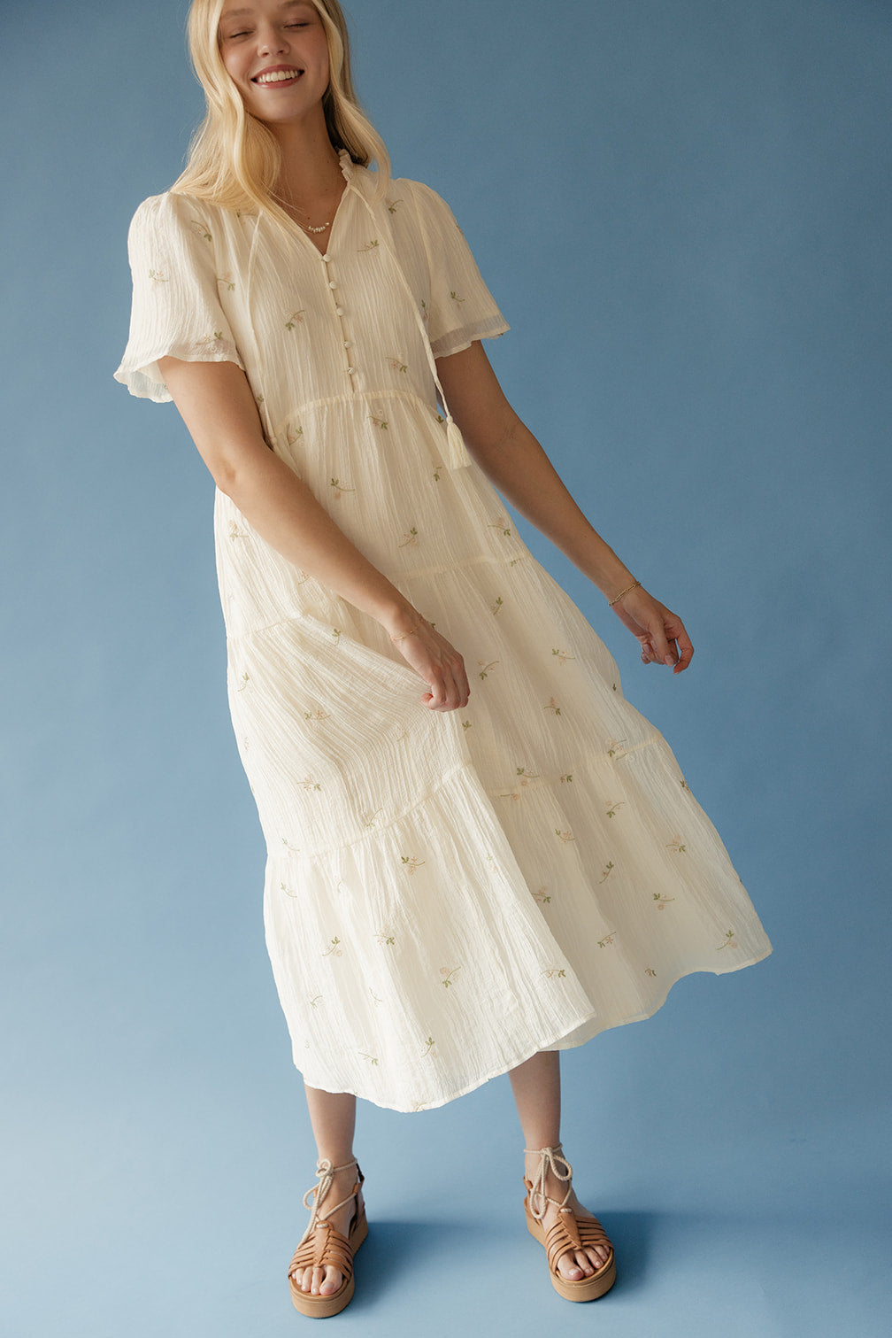 Woman wearing a white dress with a blue background