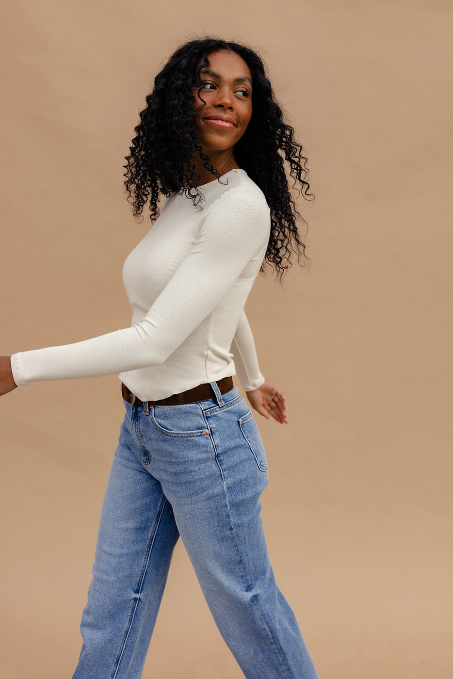 a woman in a white shirt and blue jeans