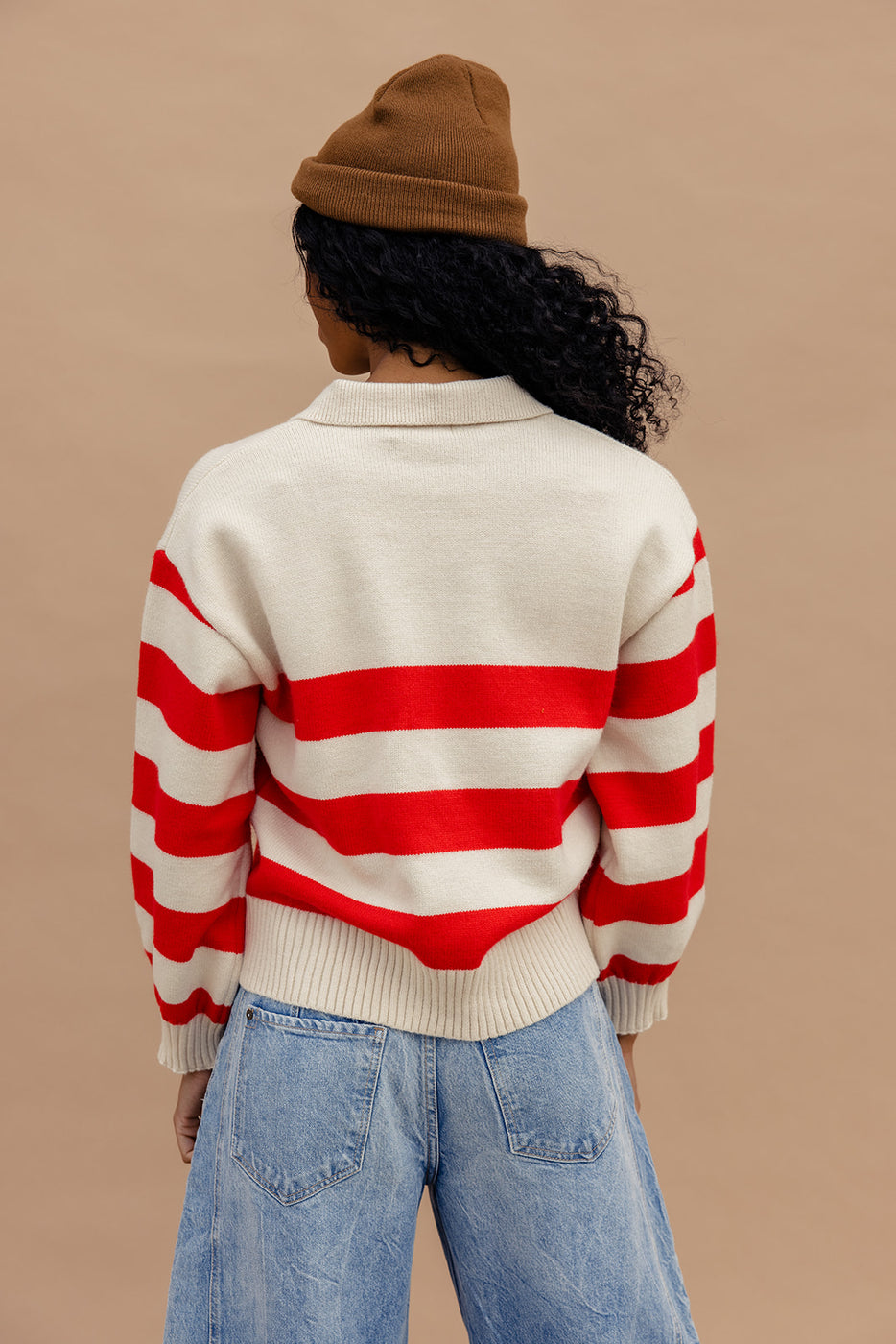 a woman wearing a red and white striped sweater