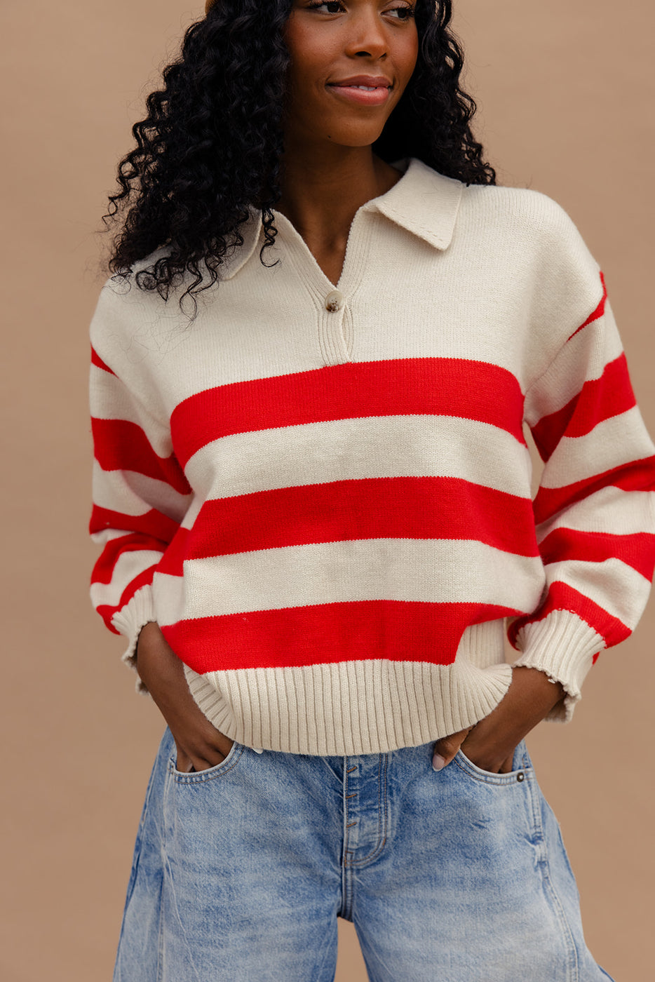 a woman wearing a red and white striped sweater