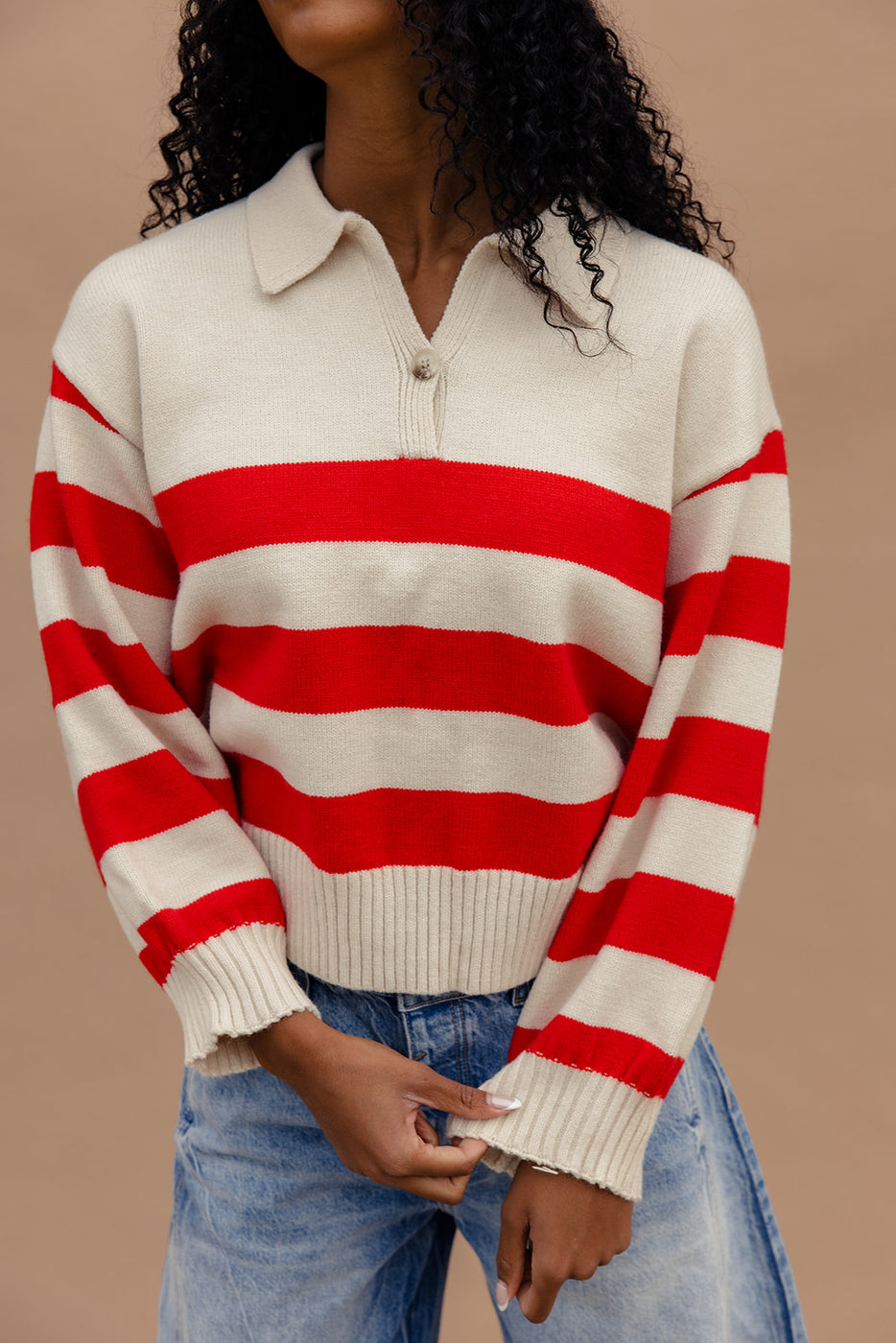 a woman wearing a red and white striped sweater