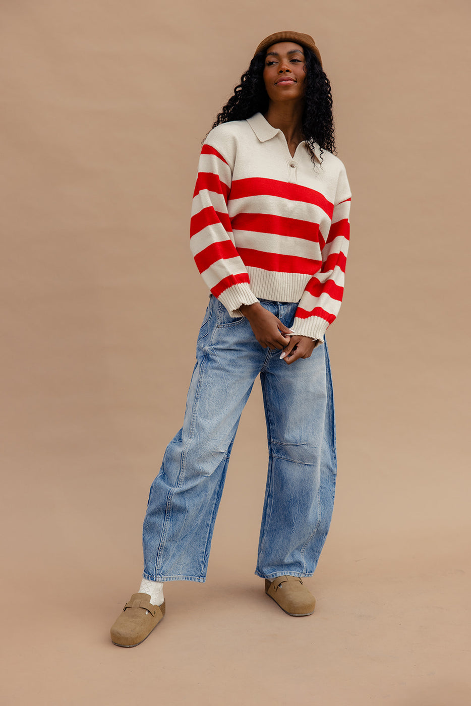 a woman in a striped sweater and jeans