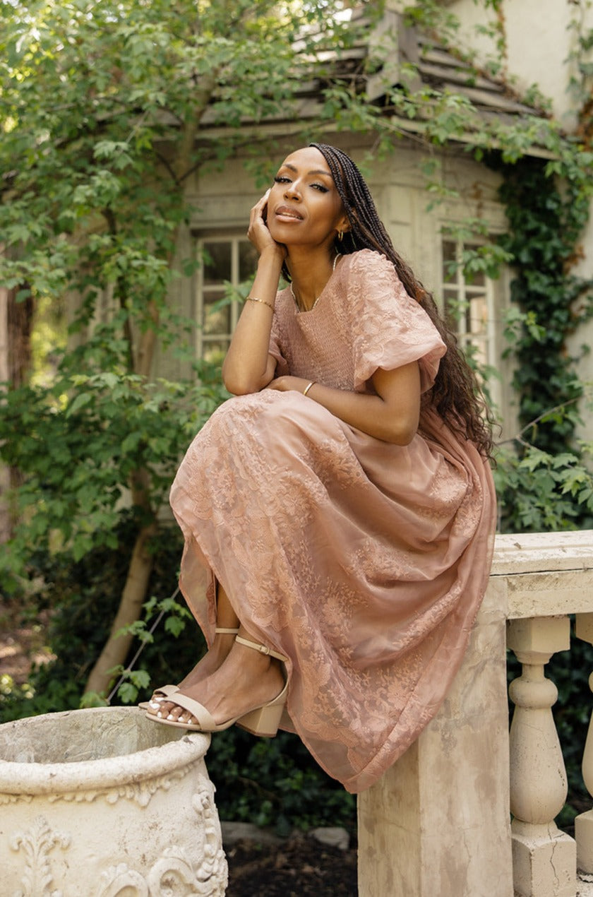 a woman sitting on a ledge