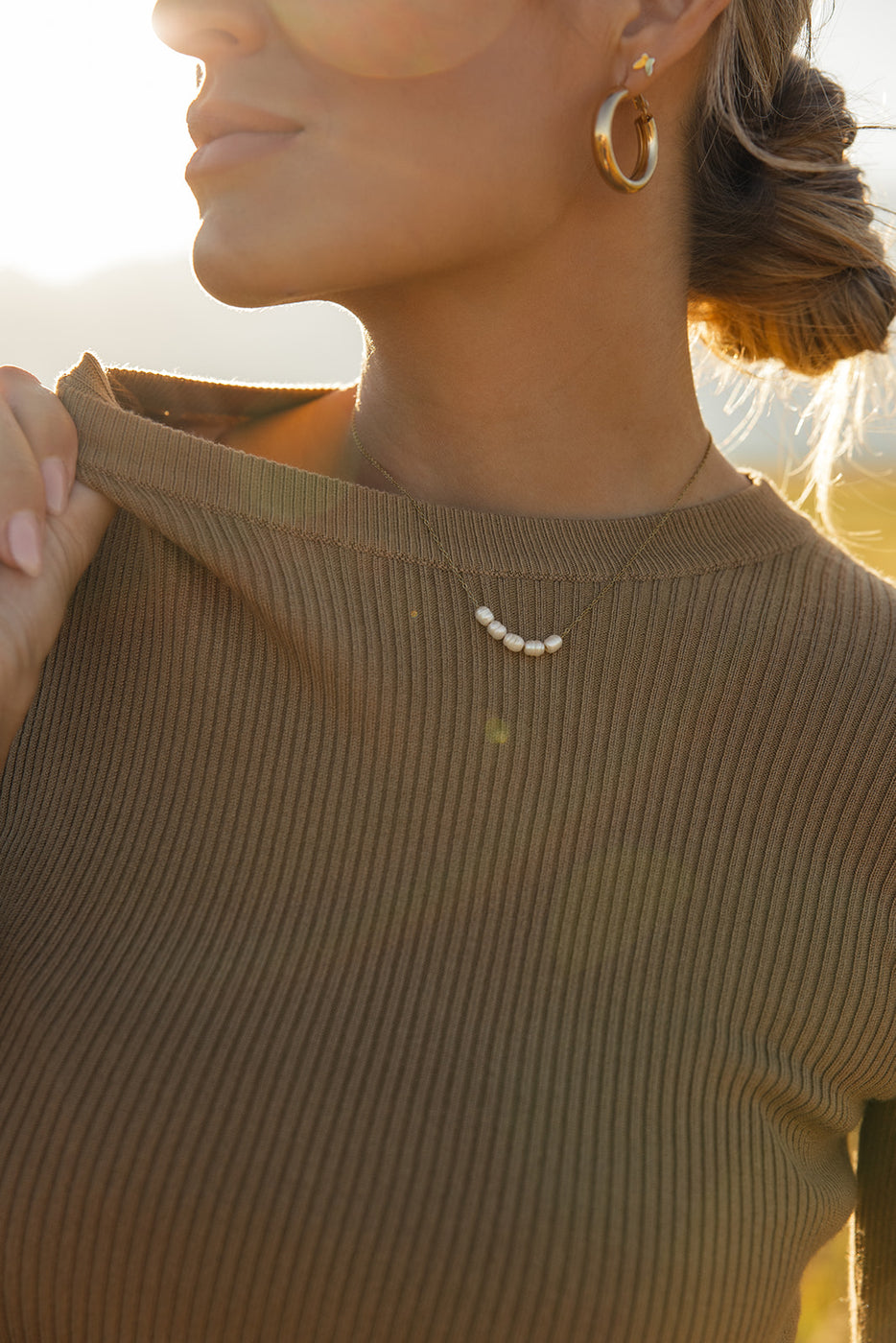 a woman wearing a necklace