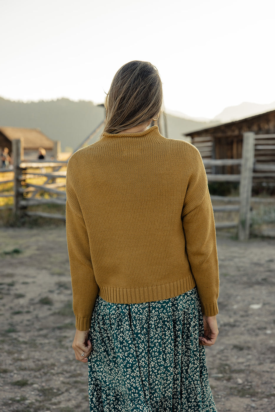 a woman in a yellow sweater