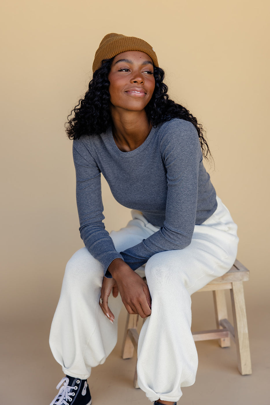 a woman sitting on a stool