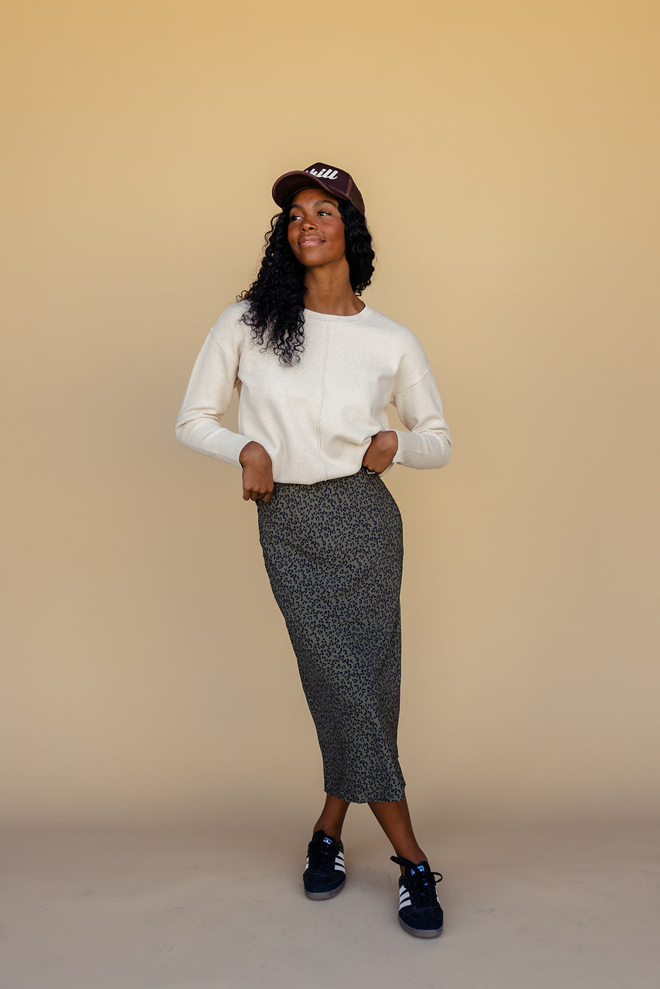 a woman in a long skirt and a white sweater