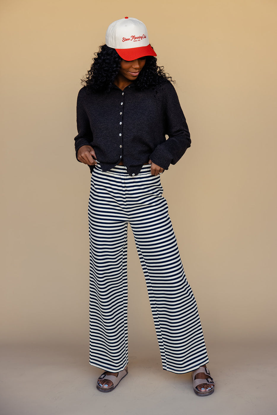 a woman in striped pants and a black shirt