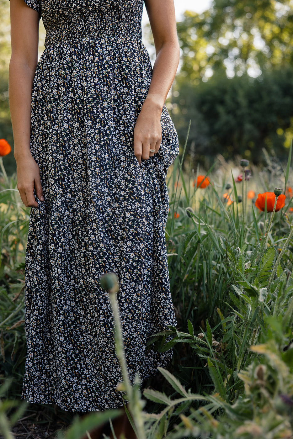 a woman wearing a dress in a field of flowers