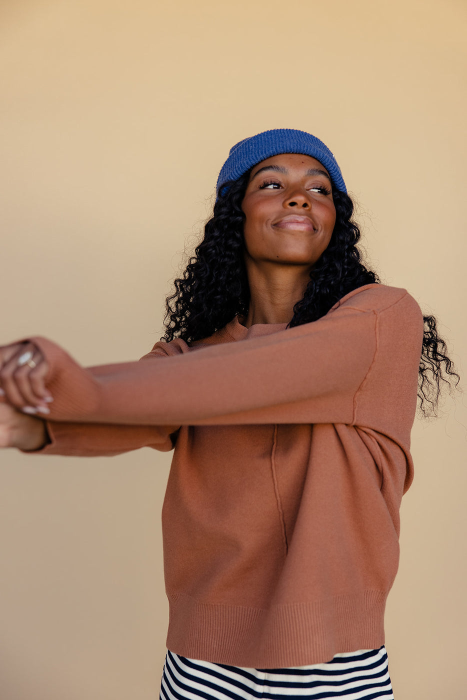 a woman wearing a hat and sweater