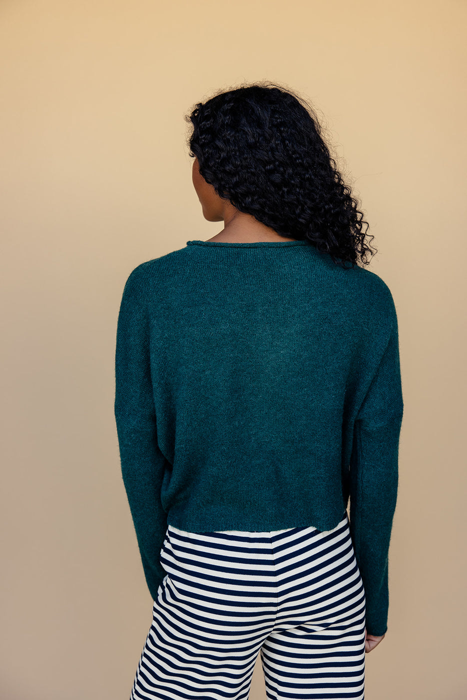 a woman in a green sweater