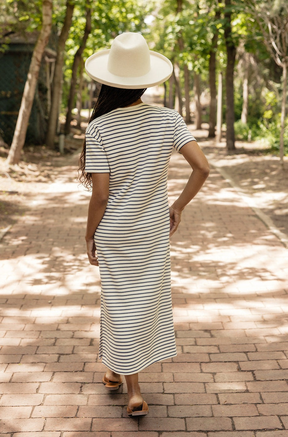 a woman wearing a hat and dress