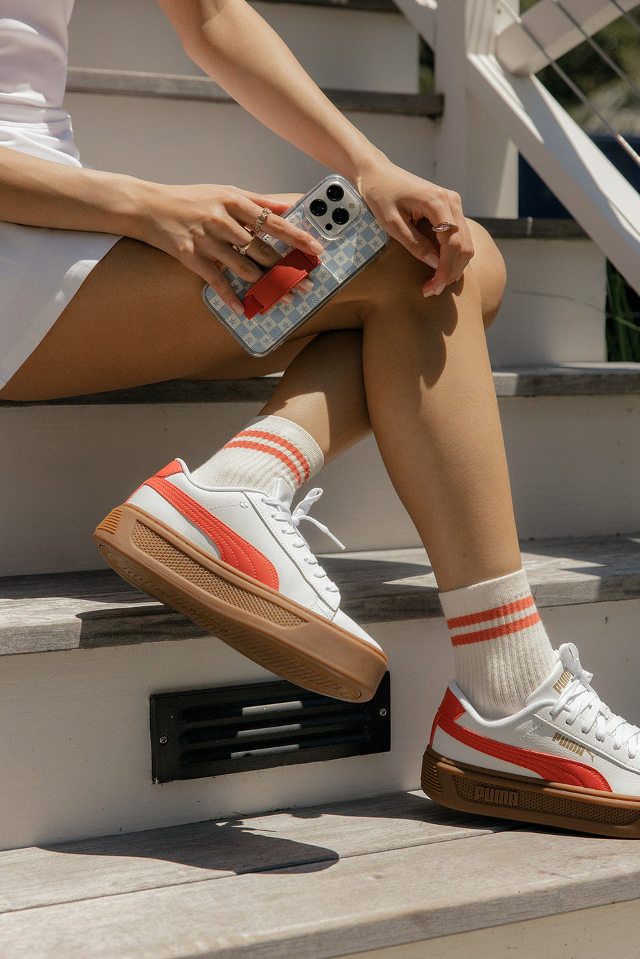 a person sitting on stairs holding a phone