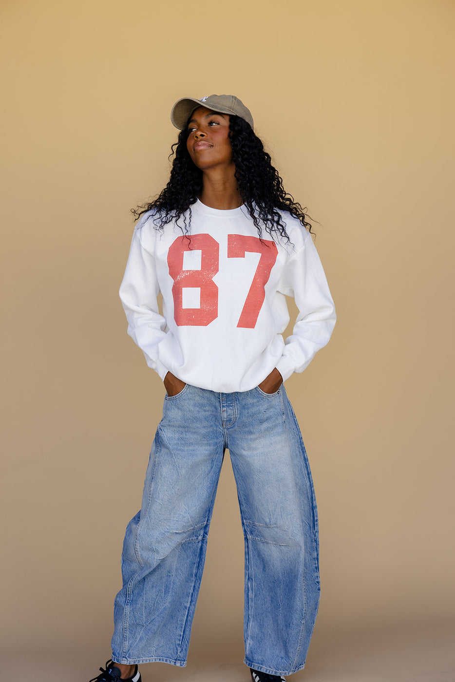 a woman wearing a hat and a white shirt