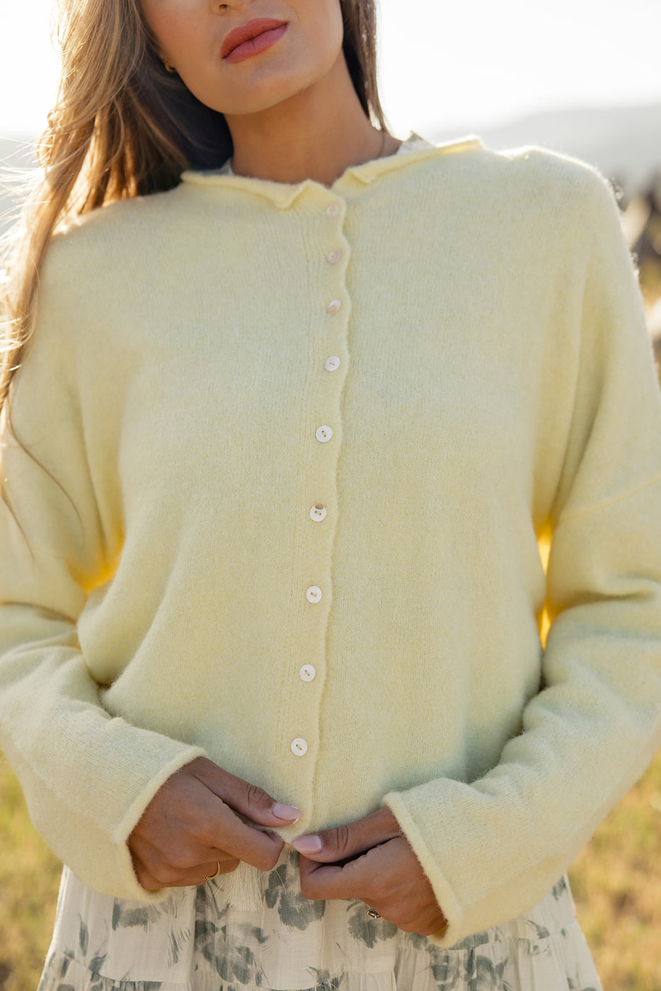 a woman wearing a yellow sweater