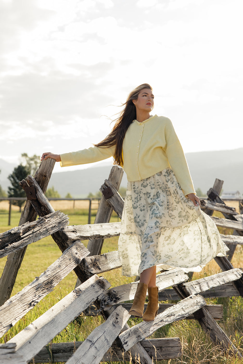 a woman standing in front of a fence