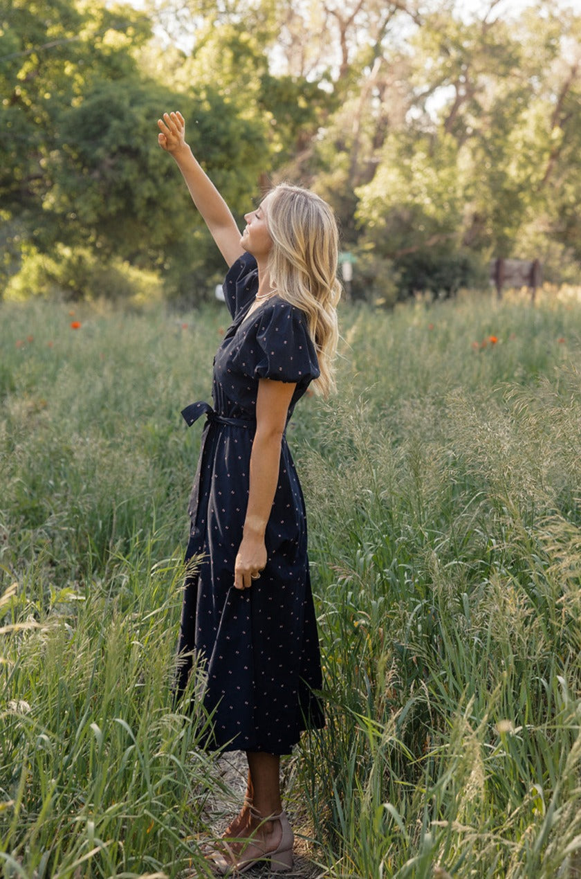 a woman in a dress in tall grass