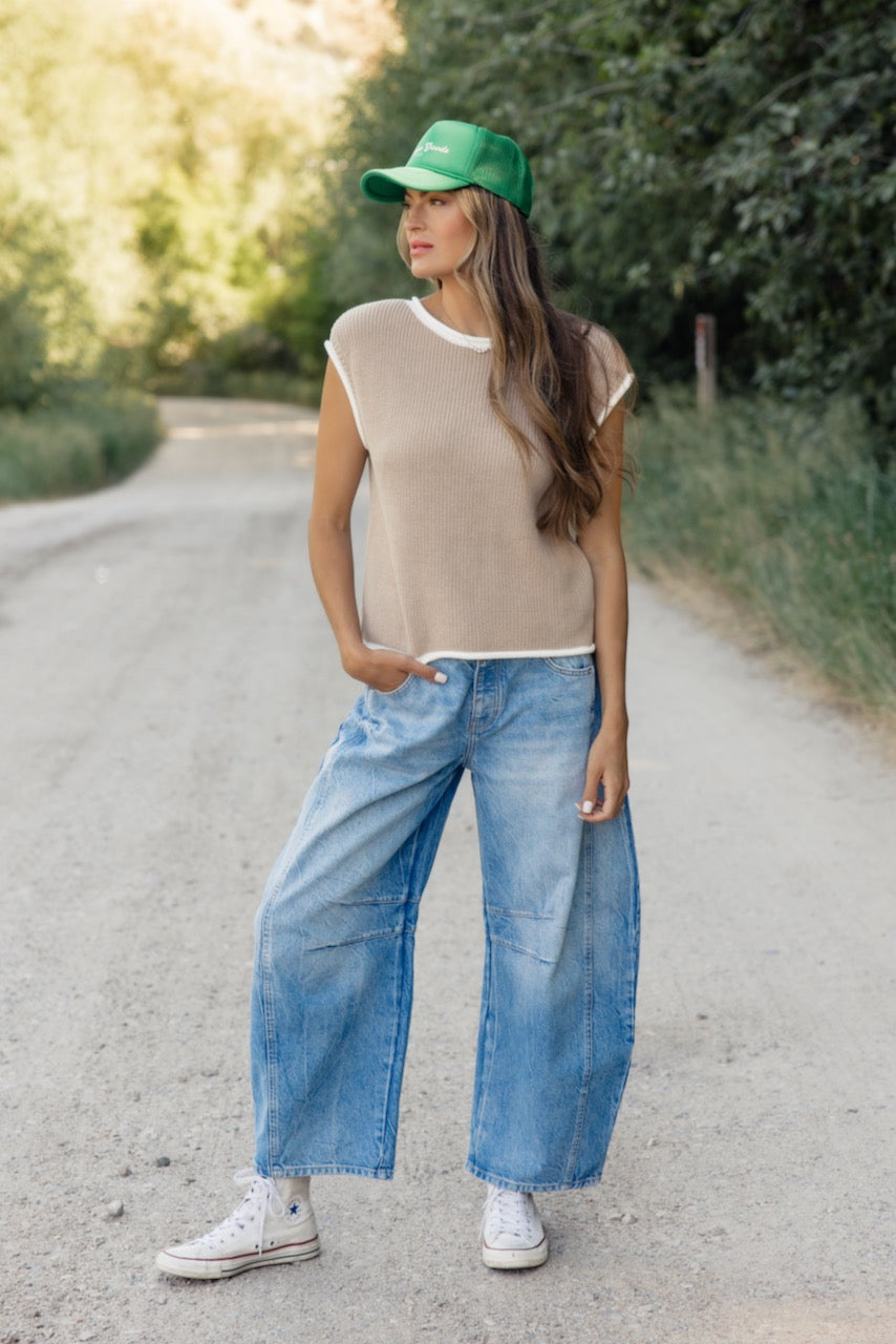 a woman standing on a dirt road