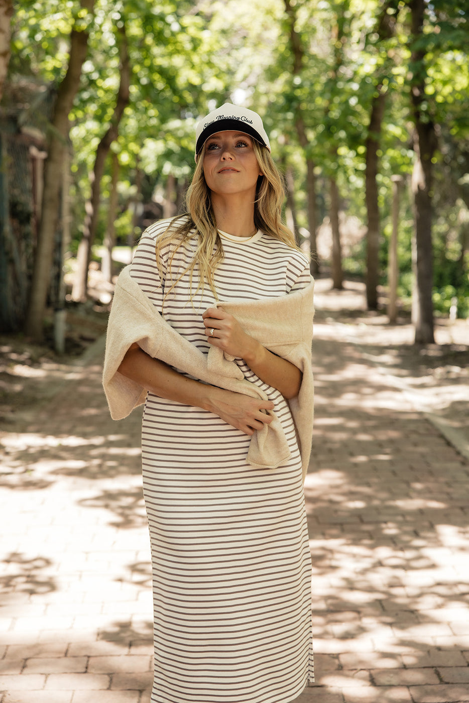 a woman in a striped dress and hat