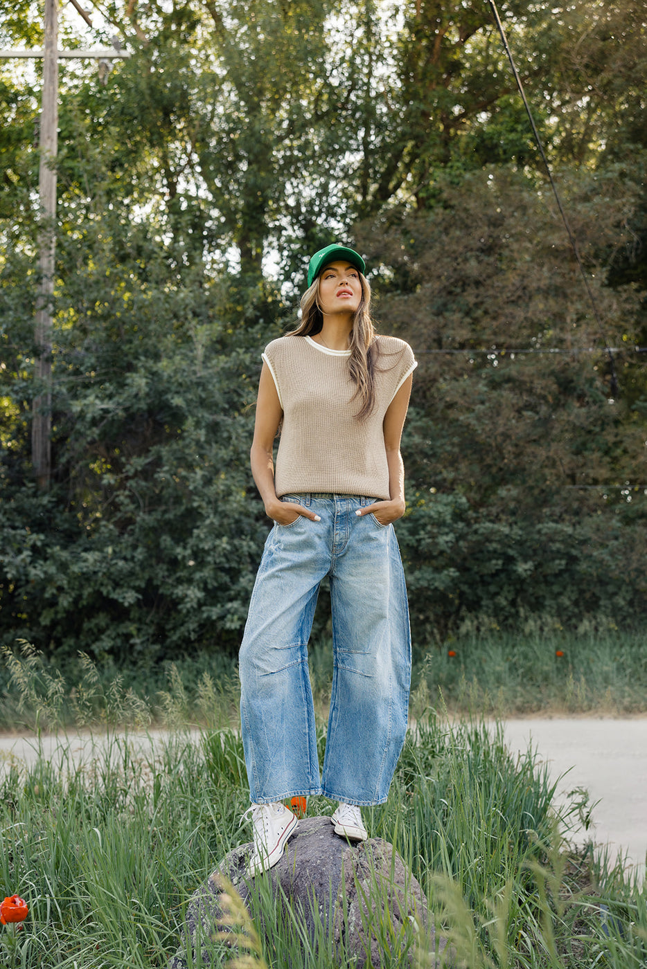 a woman standing in a grassy area