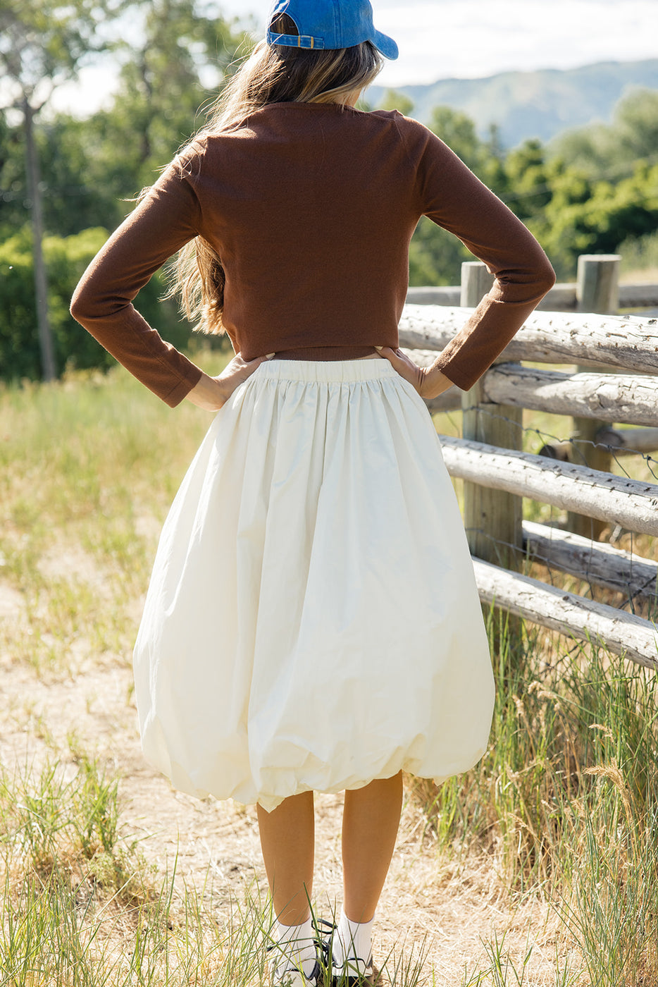 a woman standing in a field