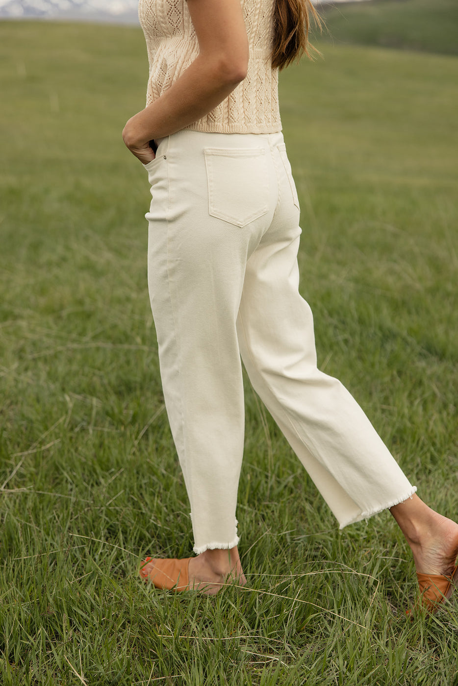 a person in white pants and sandals