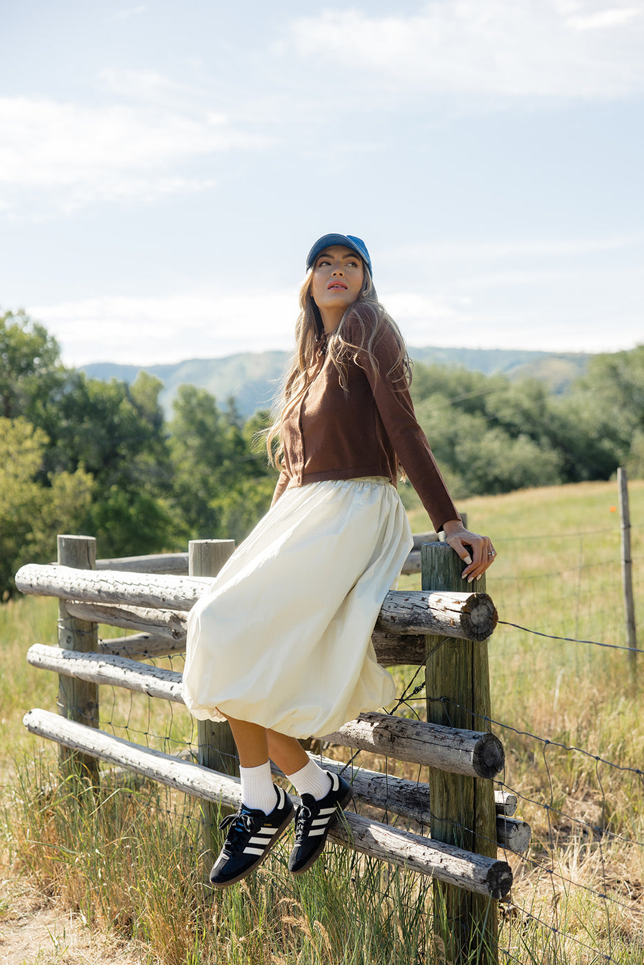 a woman sitting on a fence