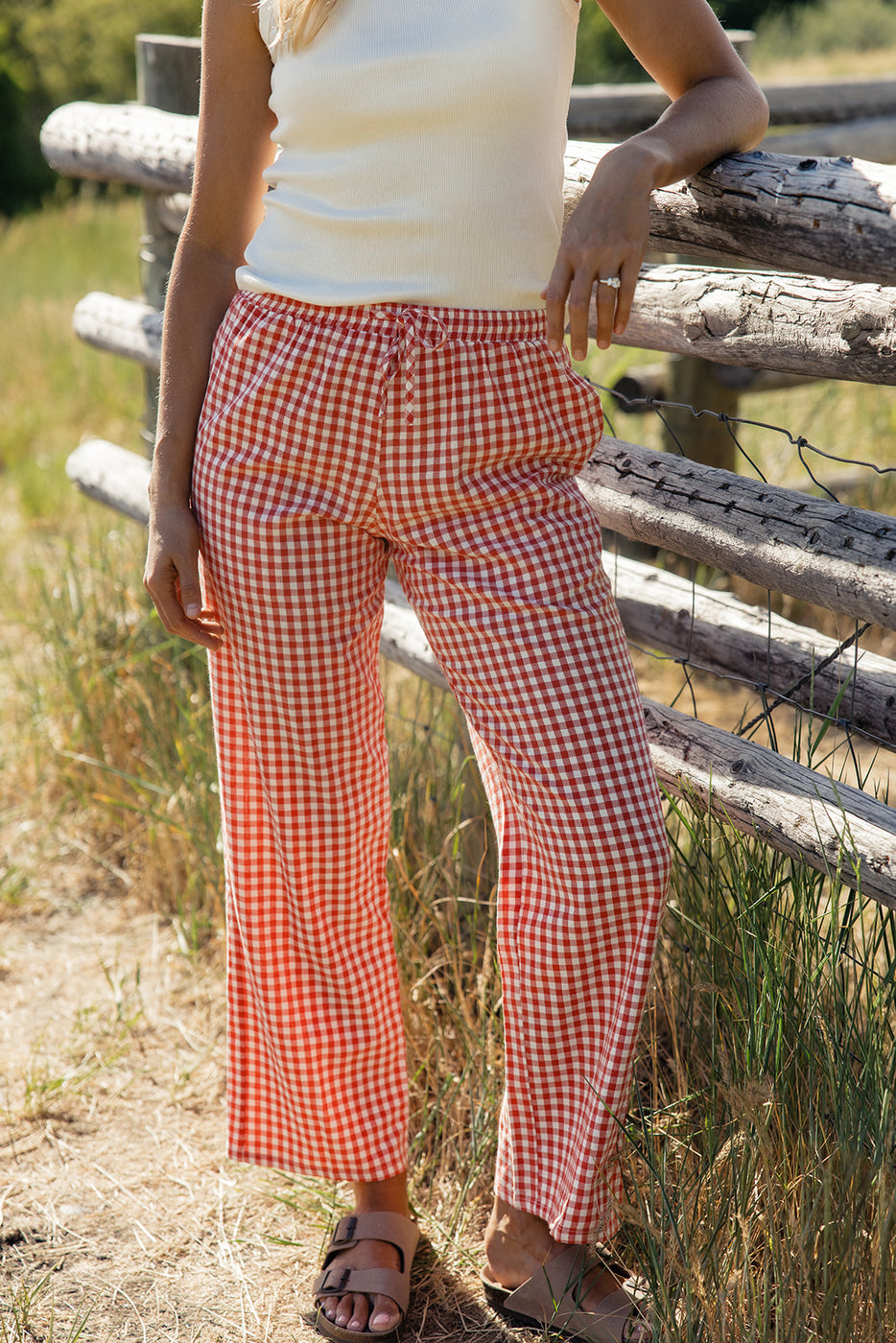 a person wearing red and white checked pants