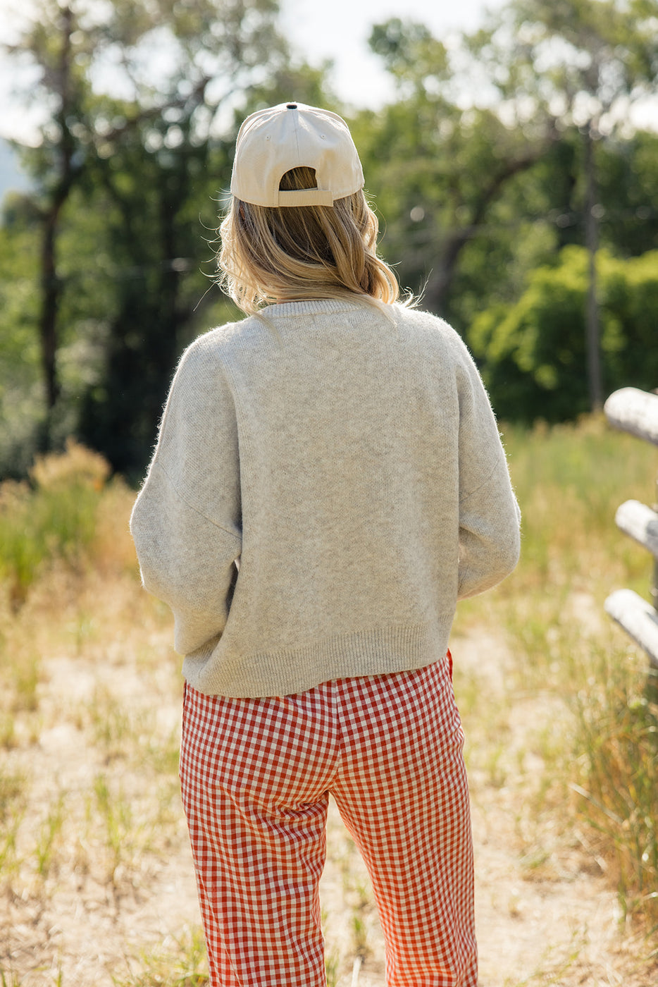 a woman wearing a hat and sweater