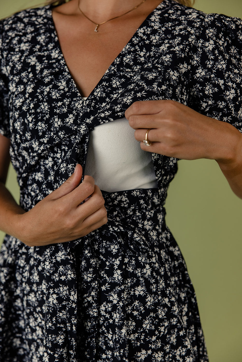 a woman putting on a dress