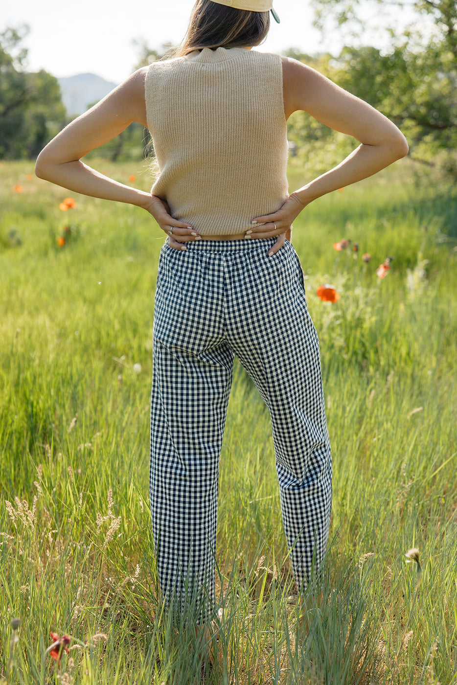 a woman standing in a field of tall grass