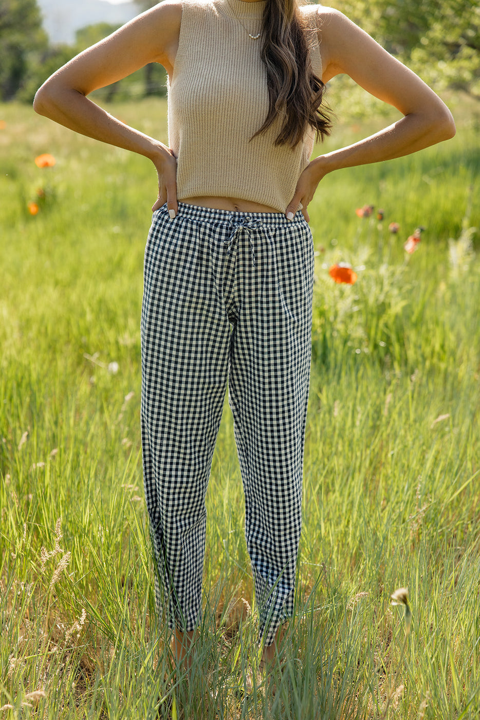 a woman standing in a field of grass