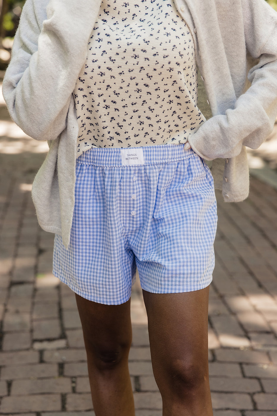a person wearing a pair of blue and white checkered shorts