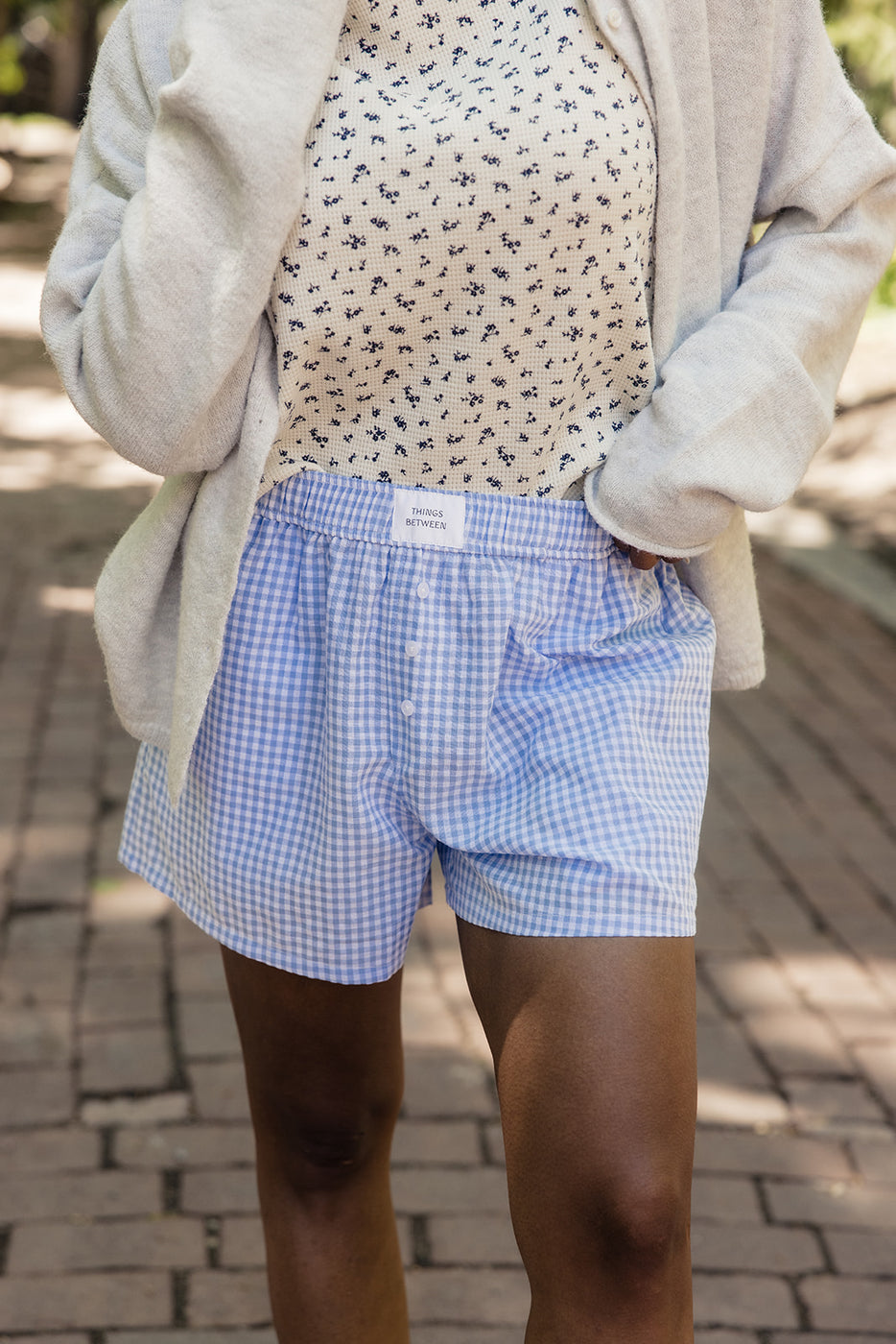 a person wearing a pair of blue and white checkered shorts