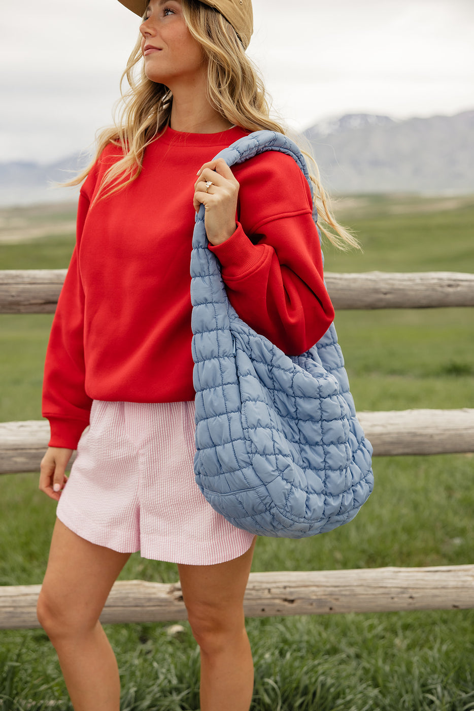 a woman holding a blue bag