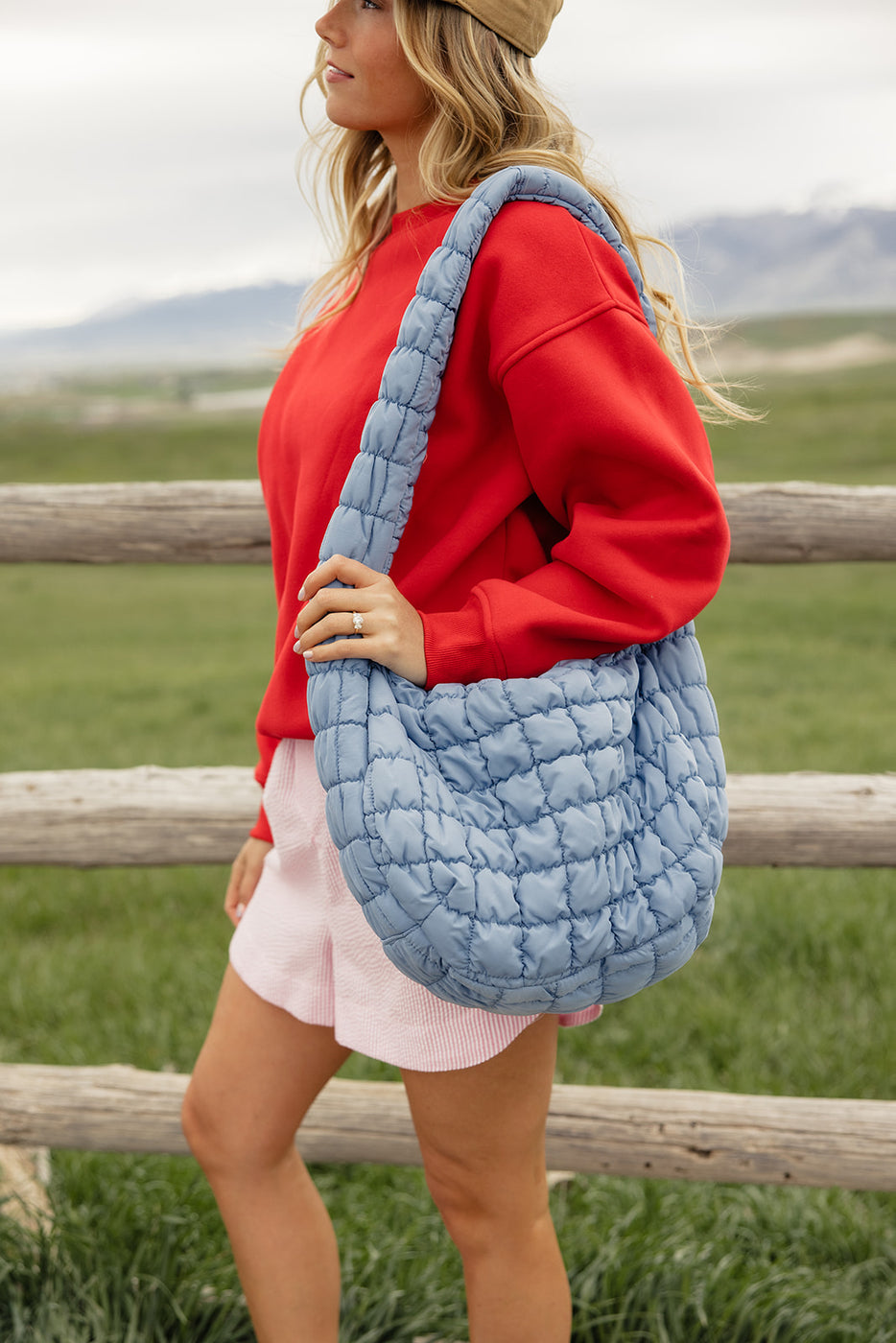 a woman holding a blue bag