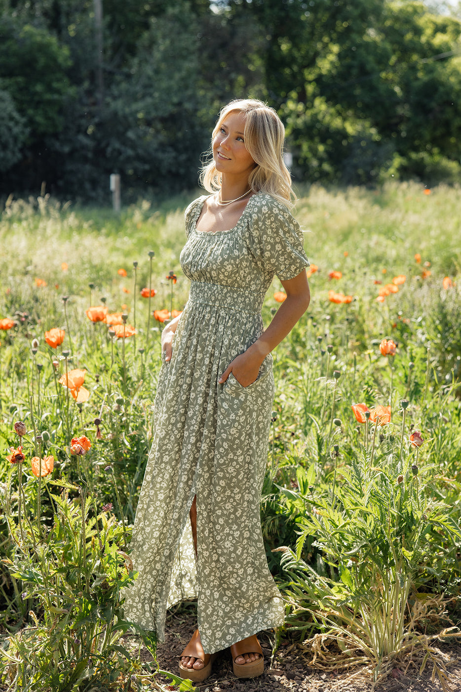 a woman in a dress in a field of flowers