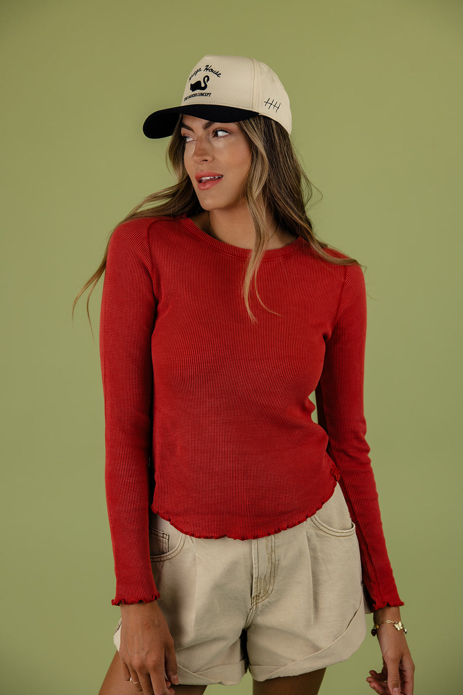 a woman in a red shirt and hat