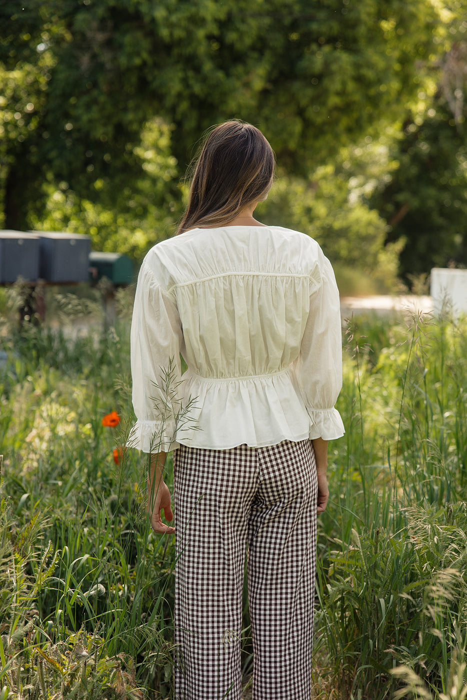 a woman standing in tall grass