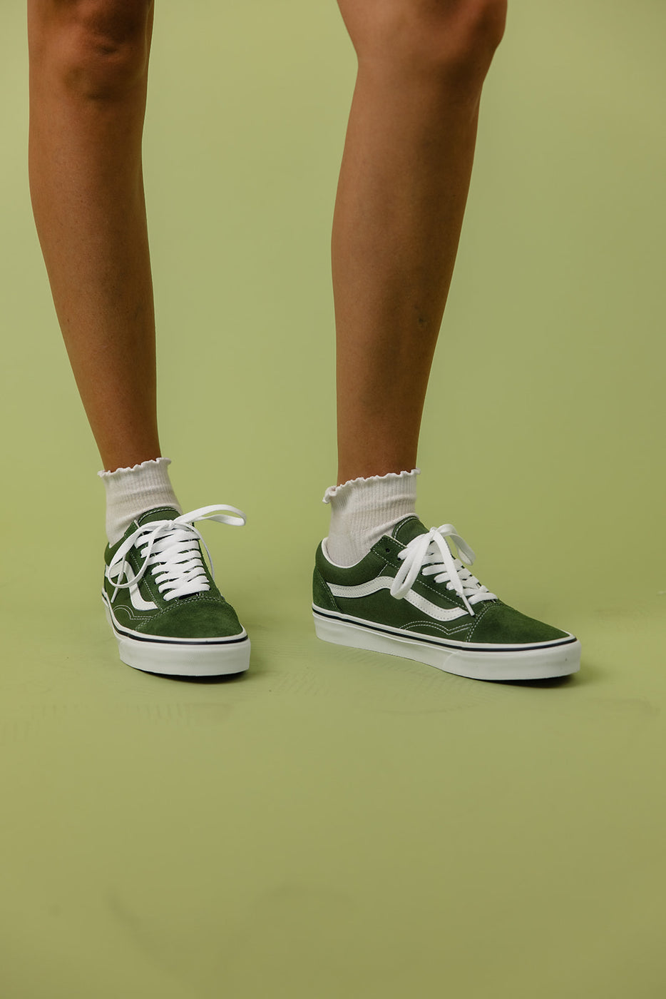 a person wearing green shoes and white socks