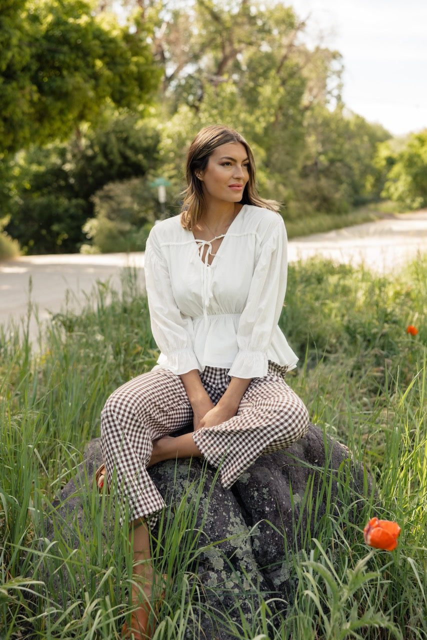 a woman sitting on a rock