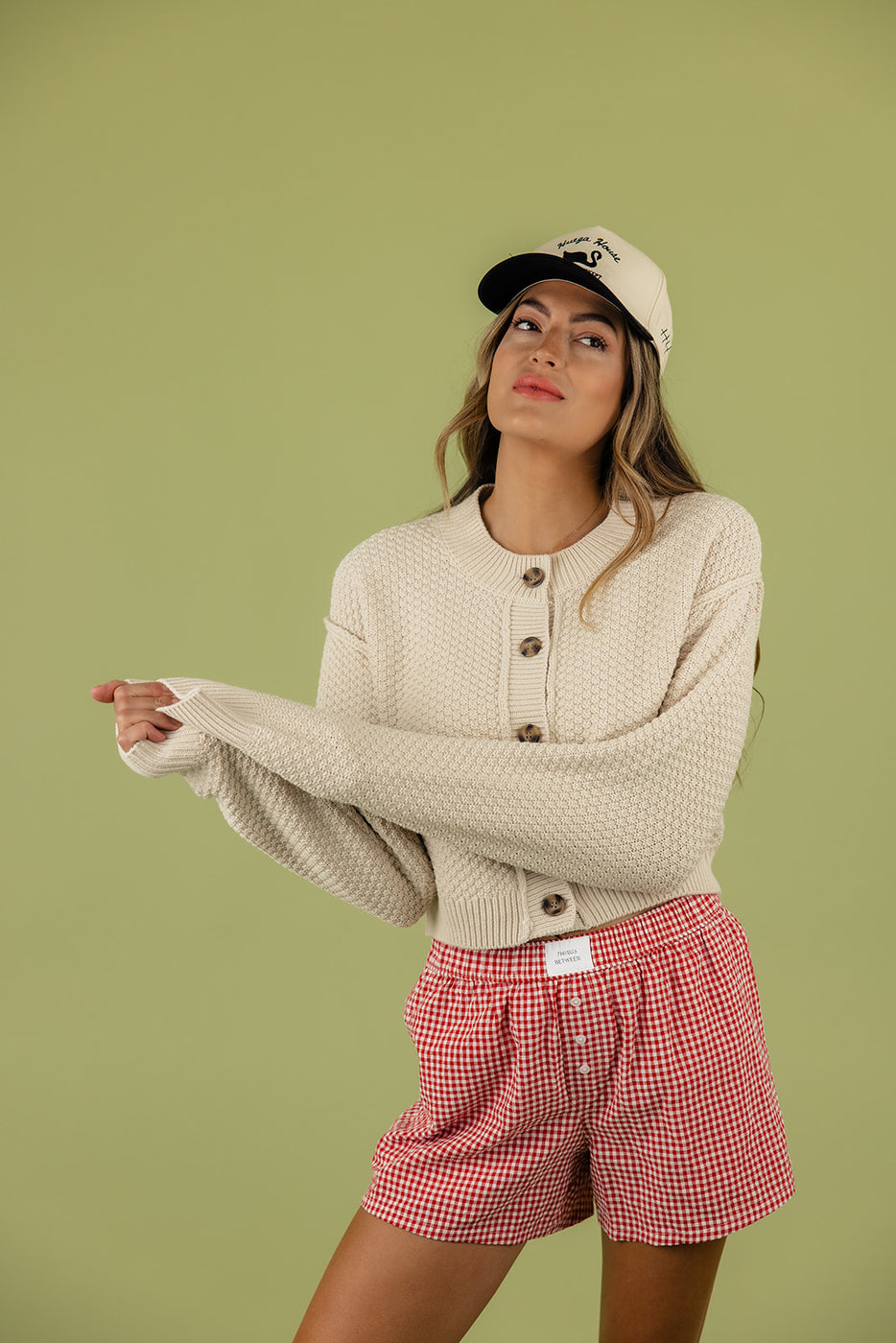 a woman wearing a hat and sweater